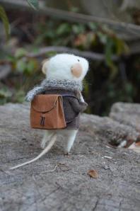 photo of white mouse withbackpack